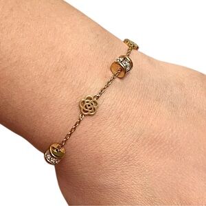 Elegant Gold Tone Floral And Crystal Charm Bracelet